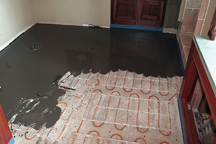 A heated floor being installed in bathroom.